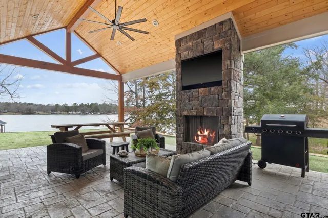 a living room with furniture and a floor to ceiling window