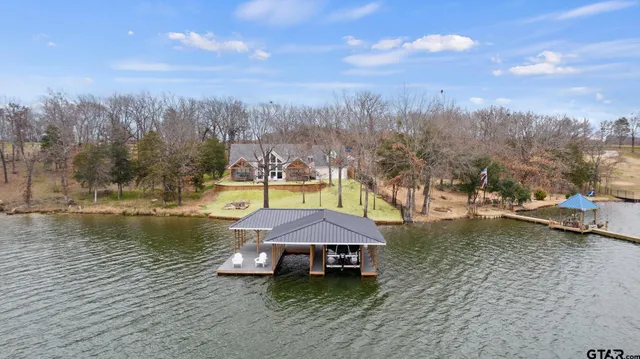 a view of a house with a yard balcony and sitting area