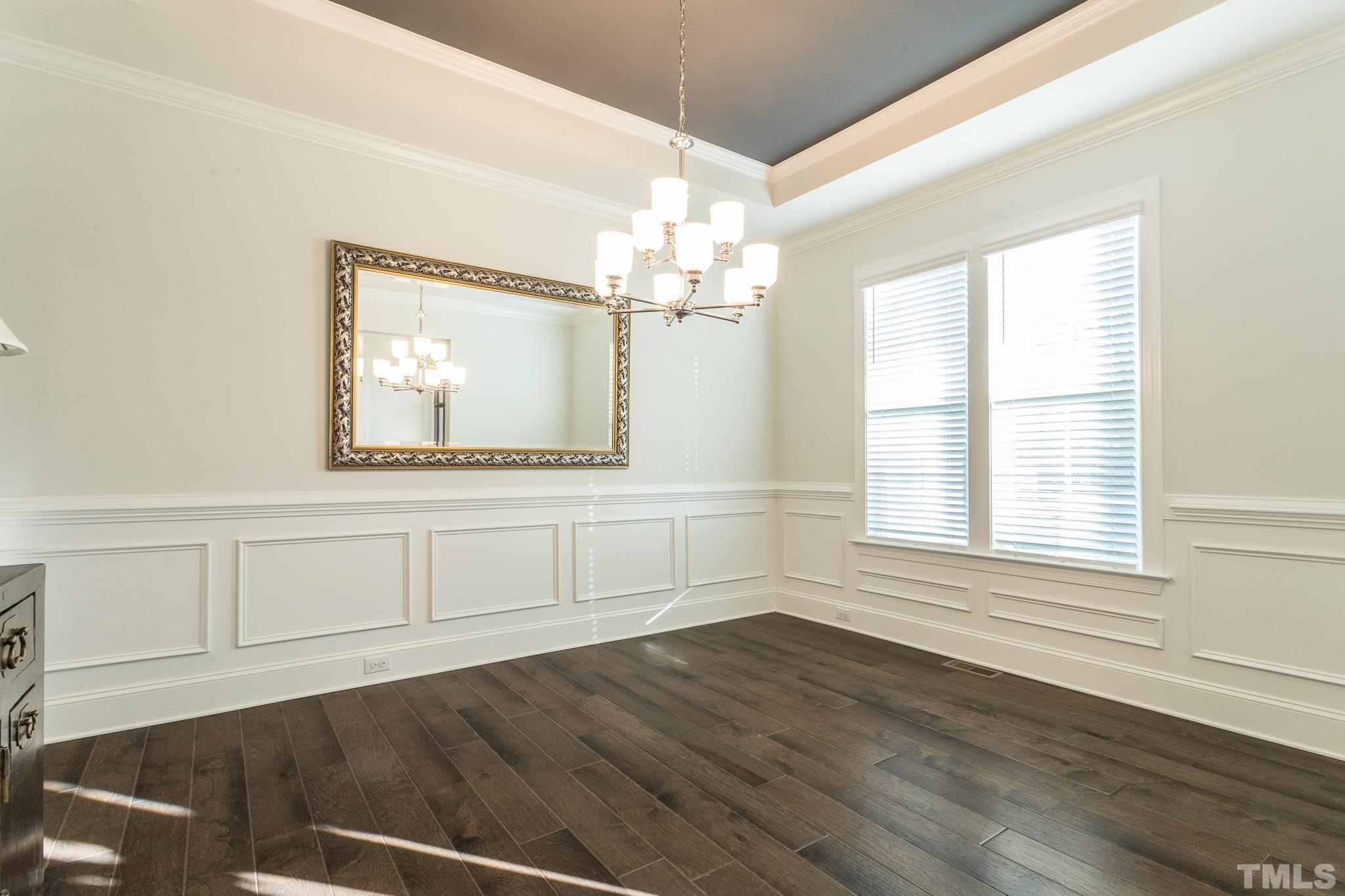 5601 Norcrest Street Raleigh, NC 27612 - Photo 18 of 41 a view of a livingroom with wooden floor windows and chandelier