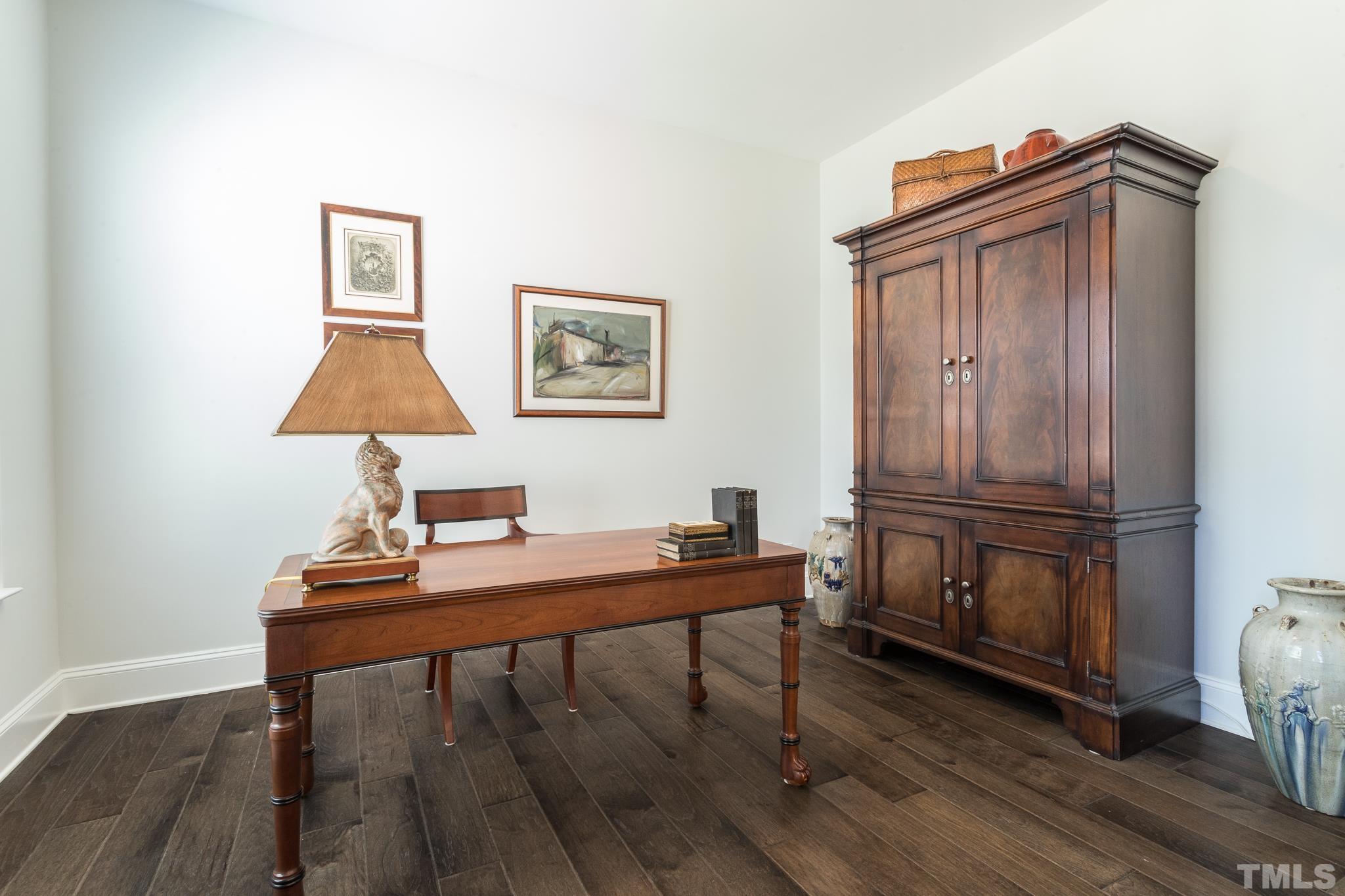 5601 Norcrest Street Raleigh, NC 27612 - Photo 20 of 41 a view of a workspace with furniture and wooden floor