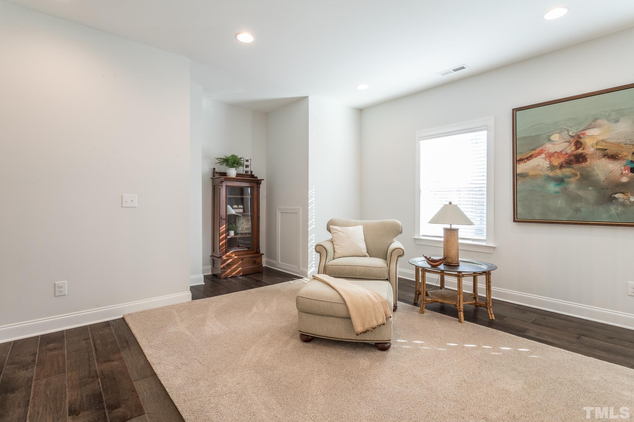 5601 Norcrest Street Raleigh, NC 27612 - Photo 33 of 41 a bedroom with furniture and a painting on the wall