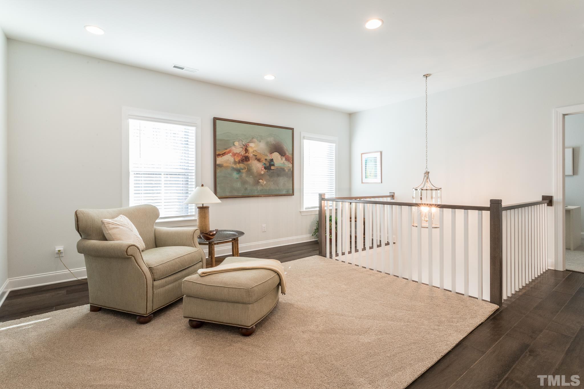 5601 Norcrest Street Raleigh, NC 27612 - Photo 34 of 41 a living room with furniture and a painting on the wall