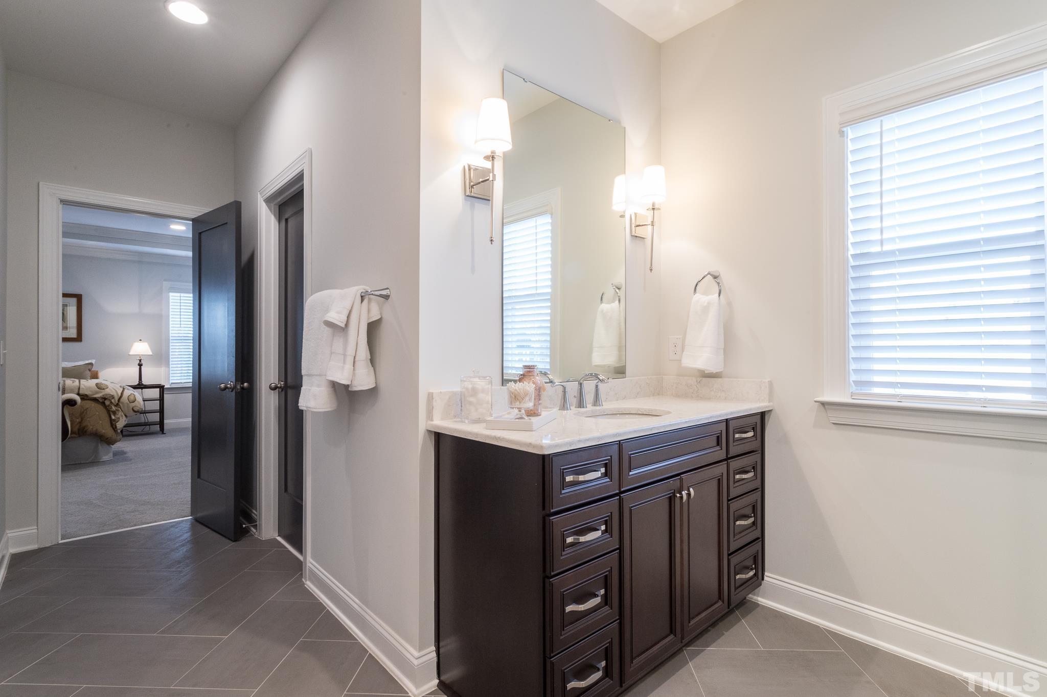 5601 Norcrest Street Raleigh, NC 27612 - Photo 38 of 41 a bathroom with a sink a vanity and a mirror