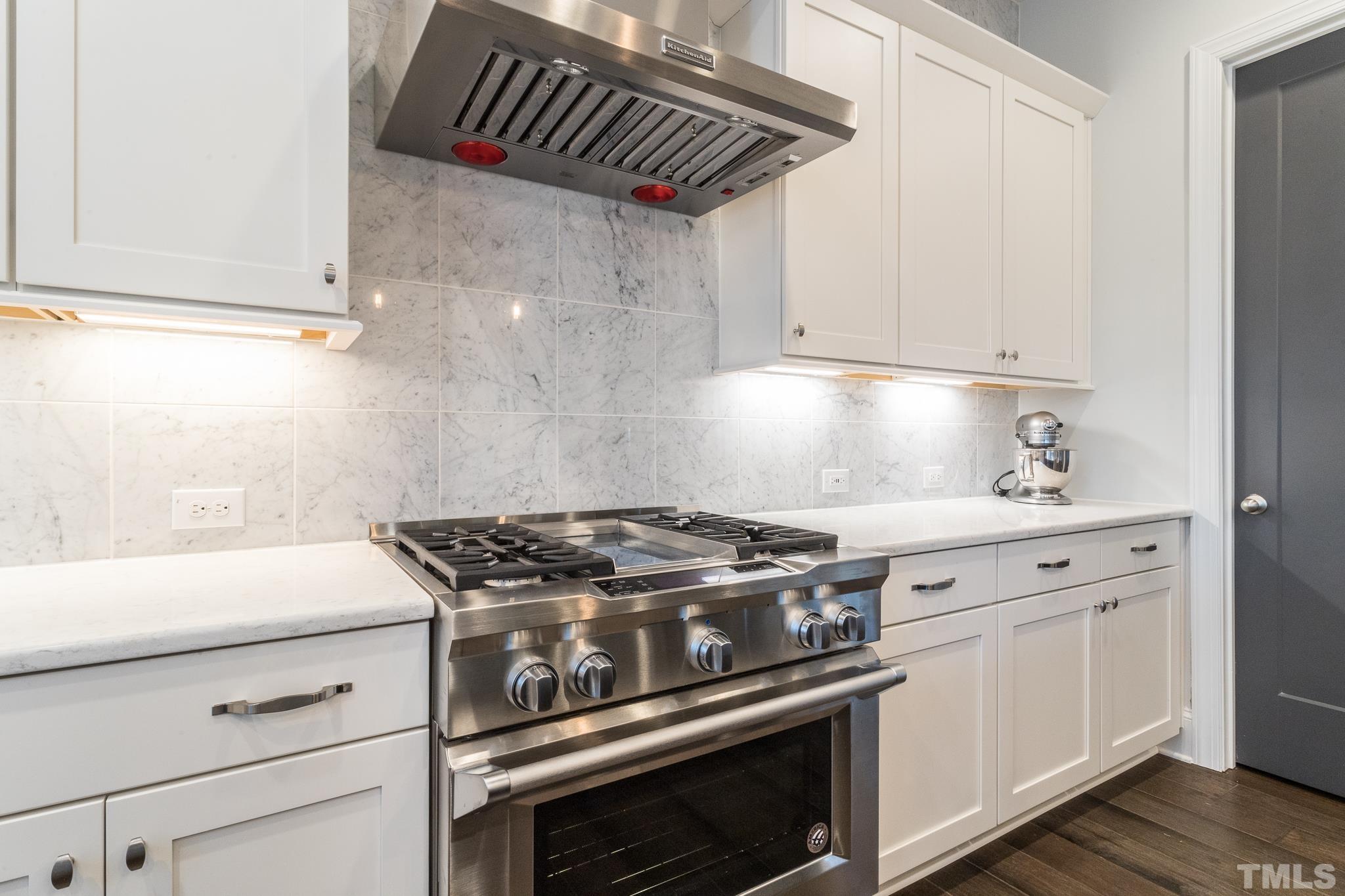 5601 Norcrest Street Raleigh, NC 27612 - Photo 5 of 41 a stove top oven sitting inside of a kitchen