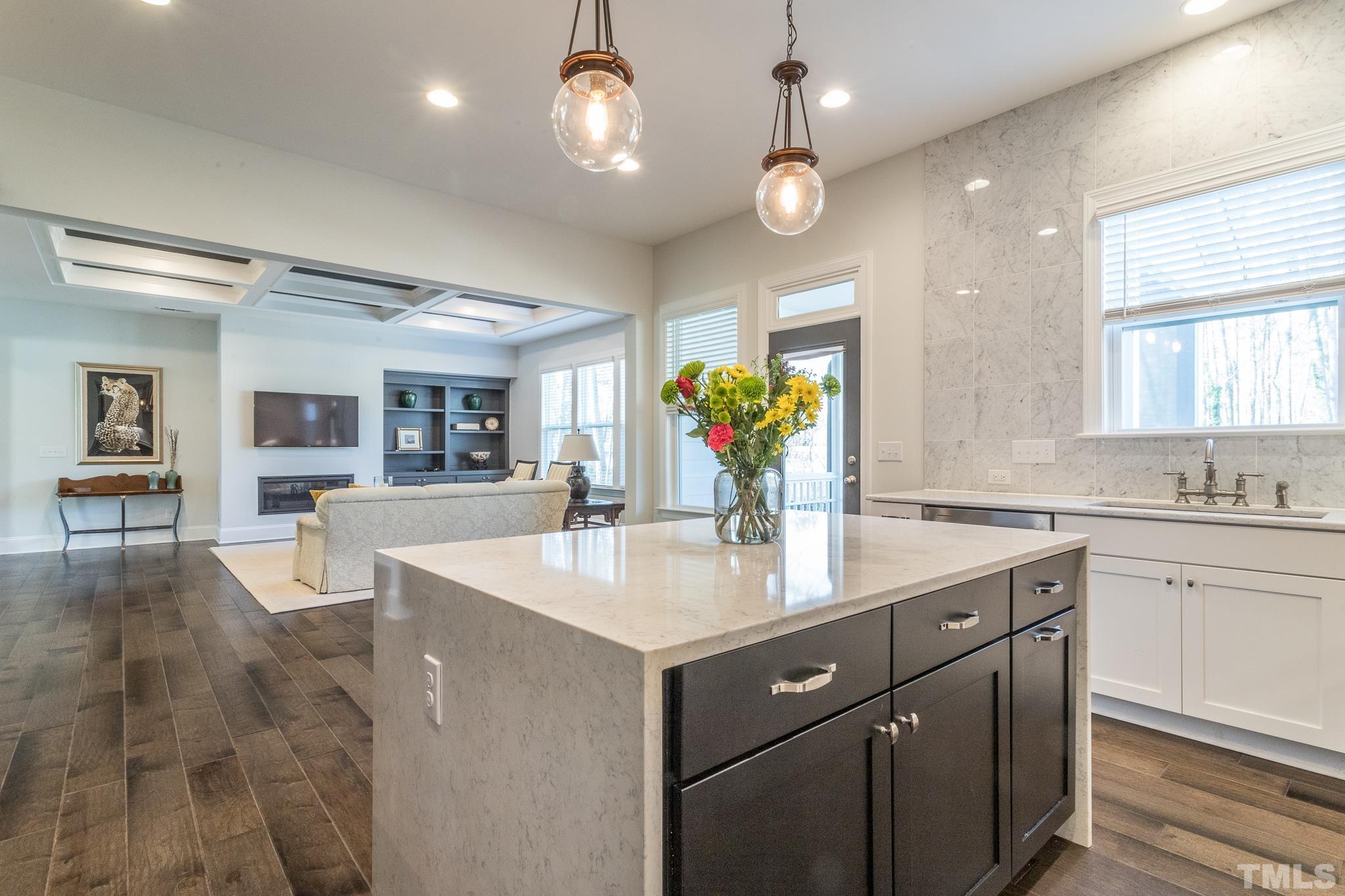5601 Norcrest Street Raleigh, NC 27612 - Photo 6 of 41 a kitchen with a sink chandelier and living room view