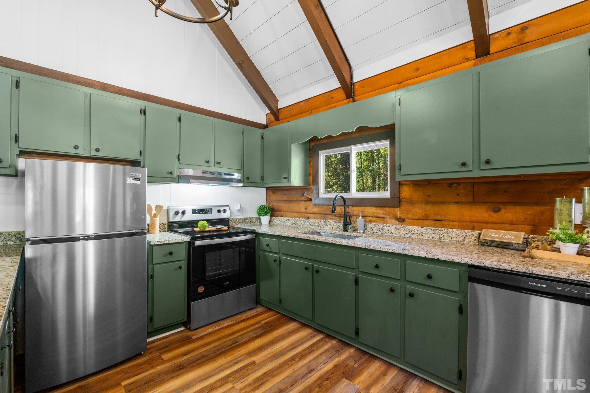2296 Nursery Road Lillington, NC 27546 - Photo 12 of 43 a kitchen with stainless steel appliances granite countertop a refrigerator a sink dishwasher a stove and white cabinets with wooden floor