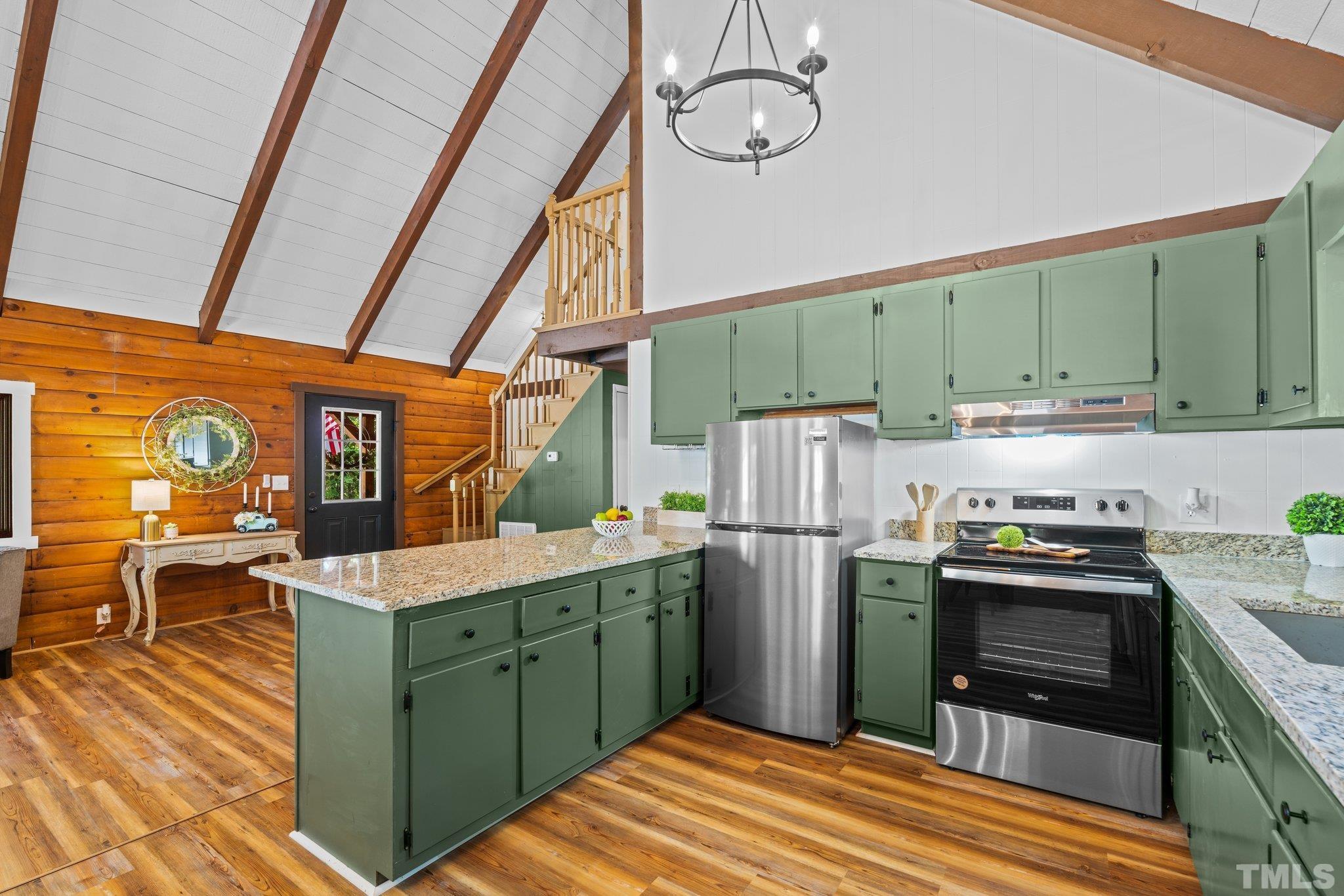 2296 Nursery Road Lillington, NC 27546 - Photo 13 of 43 a kitchen with a refrigerator and a stove top oven
