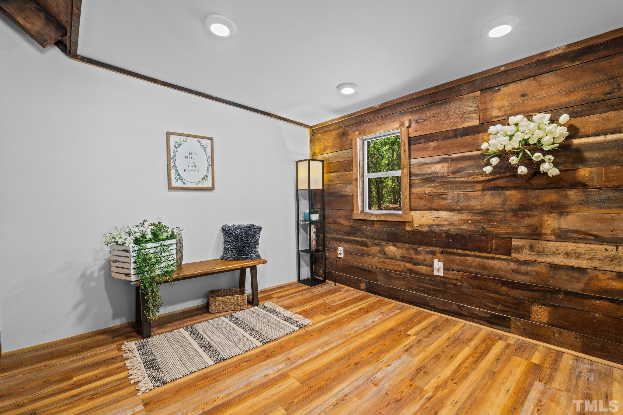 2296 Nursery Road Lillington, NC 27546 - Photo 17 of 43 a bedroom with a bed and wooden floor