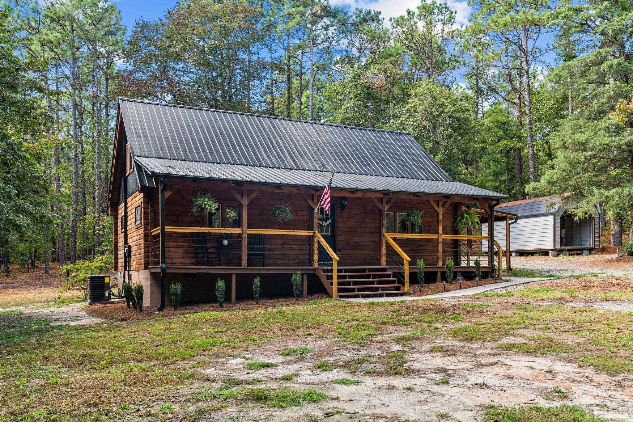 2296 Nursery Road Lillington, NC 27546 - Photo 2 of 43 a view of a house with a yard patio and wooden fence
