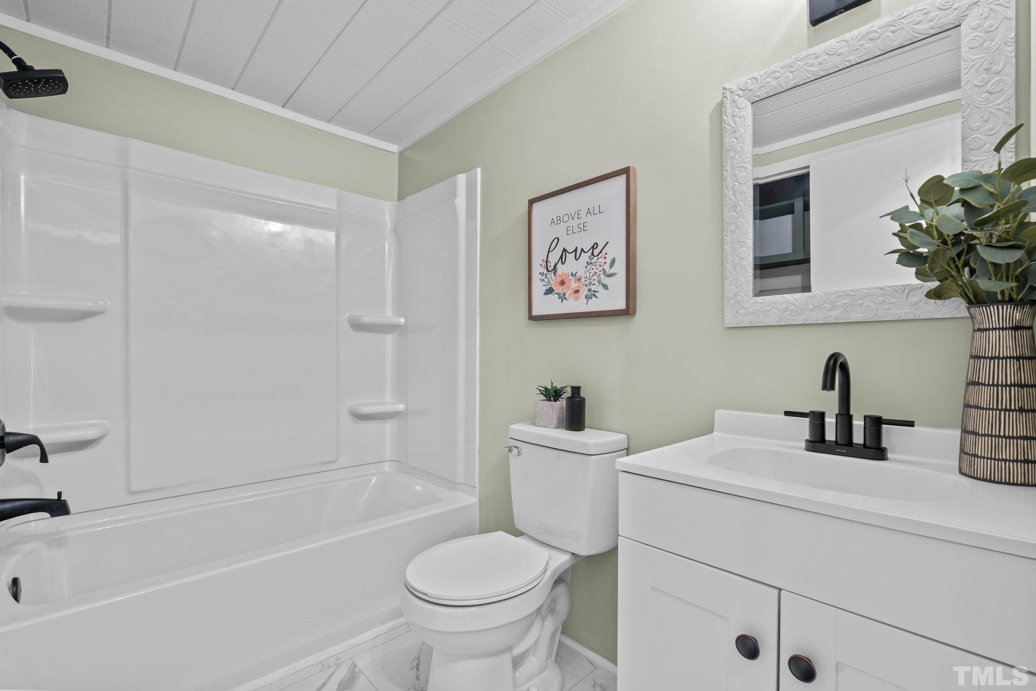 2296 Nursery Road Lillington, NC 27546 - Photo 23 of 43 a bathroom with a sink toilet and shower