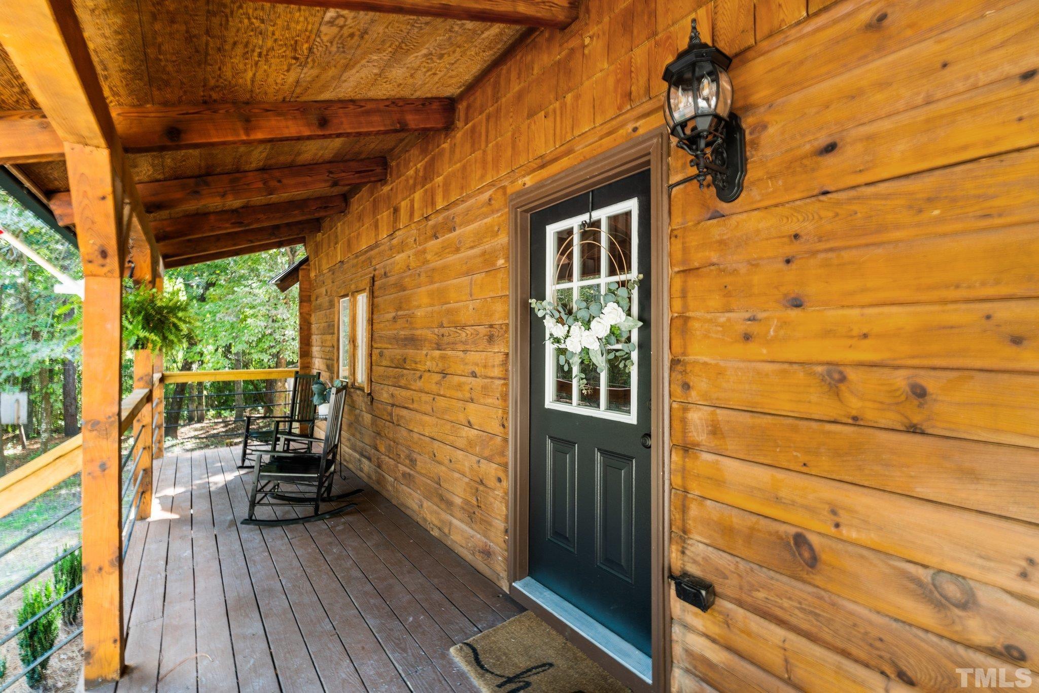 2296 Nursery Road Lillington, NC 27546 - Photo 3 of 43 a view of a balcony with chairs and wooden floor
