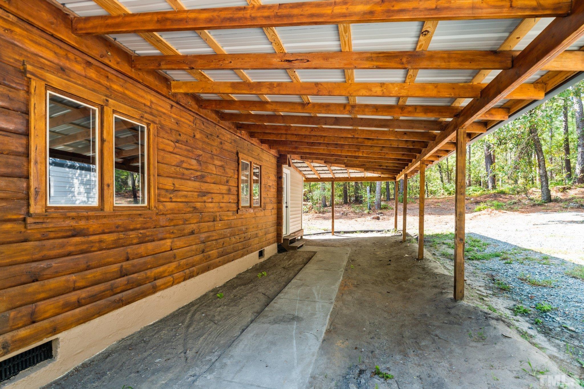 2296 Nursery Road Lillington, NC 27546 - Photo 35 of 43 a view of an empty room with a window and wooden floor