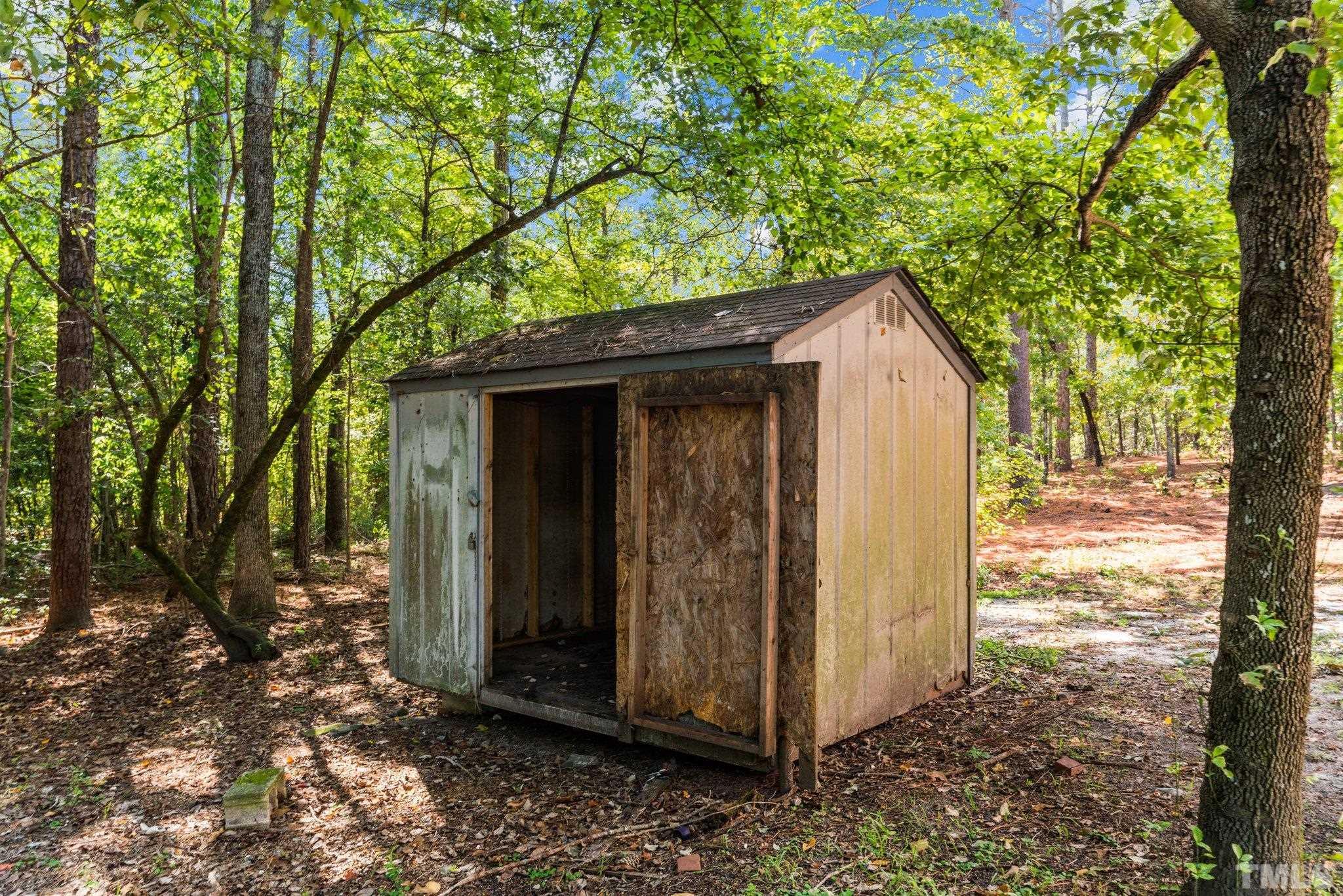 2296 Nursery Road Lillington, NC 27546 - Photo 42 of 43 a view of a small house with a tree in the yard