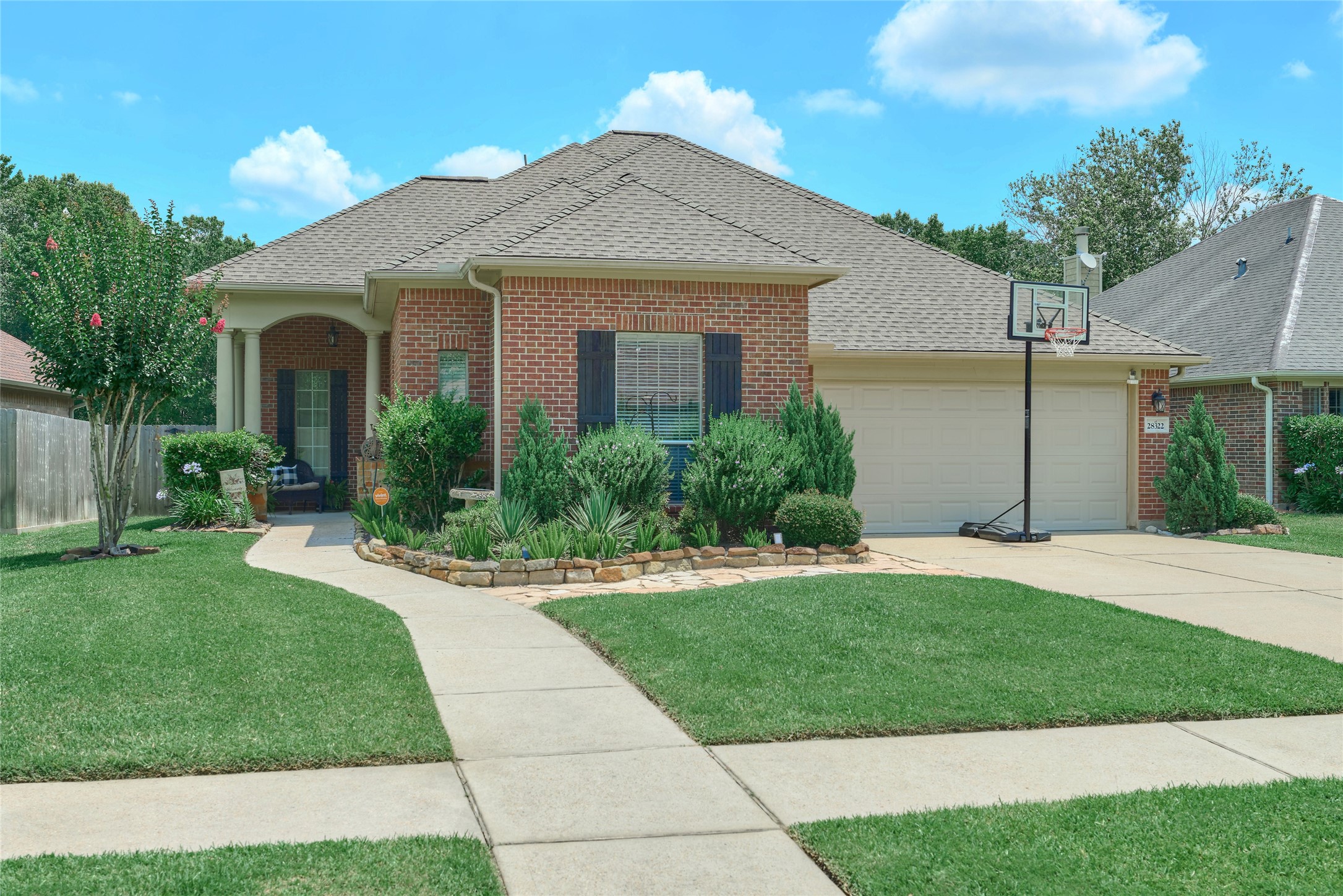 28322 Madelin Manor Lane Spring, TX 77386 - Photo 2 of 46 a front view of a house with a yard and potted plants