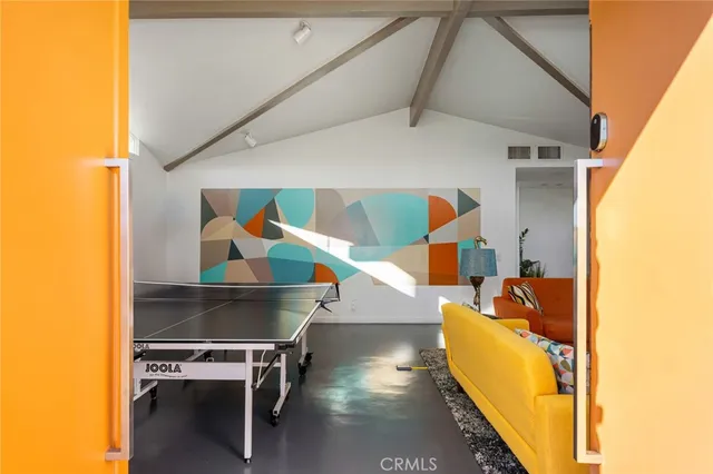 a living room with furniture a flat screen tv and a large window