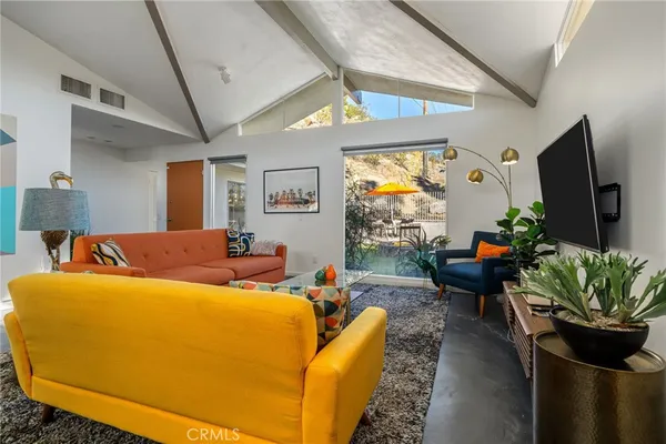 a living room with furniture a couch and a window