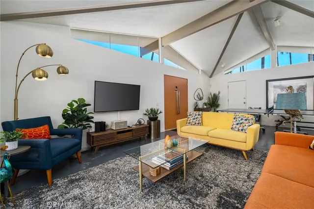 a room with gym equipment and wooden floor