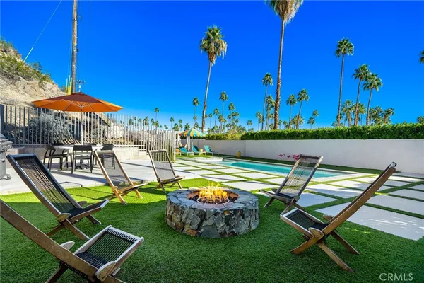 an outdoor space with furniture and umbrella