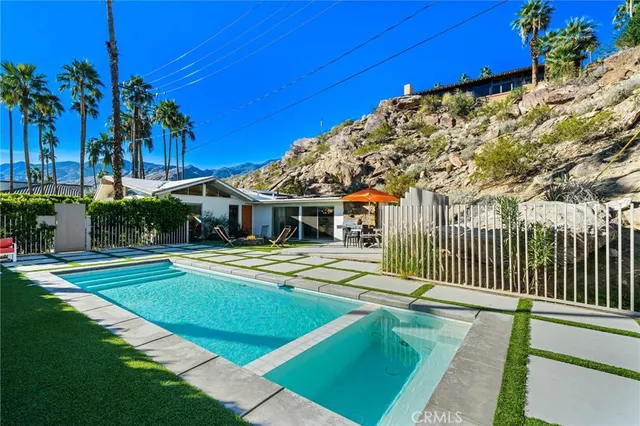 a view of an outdoor sitting area with furniture and umbrella