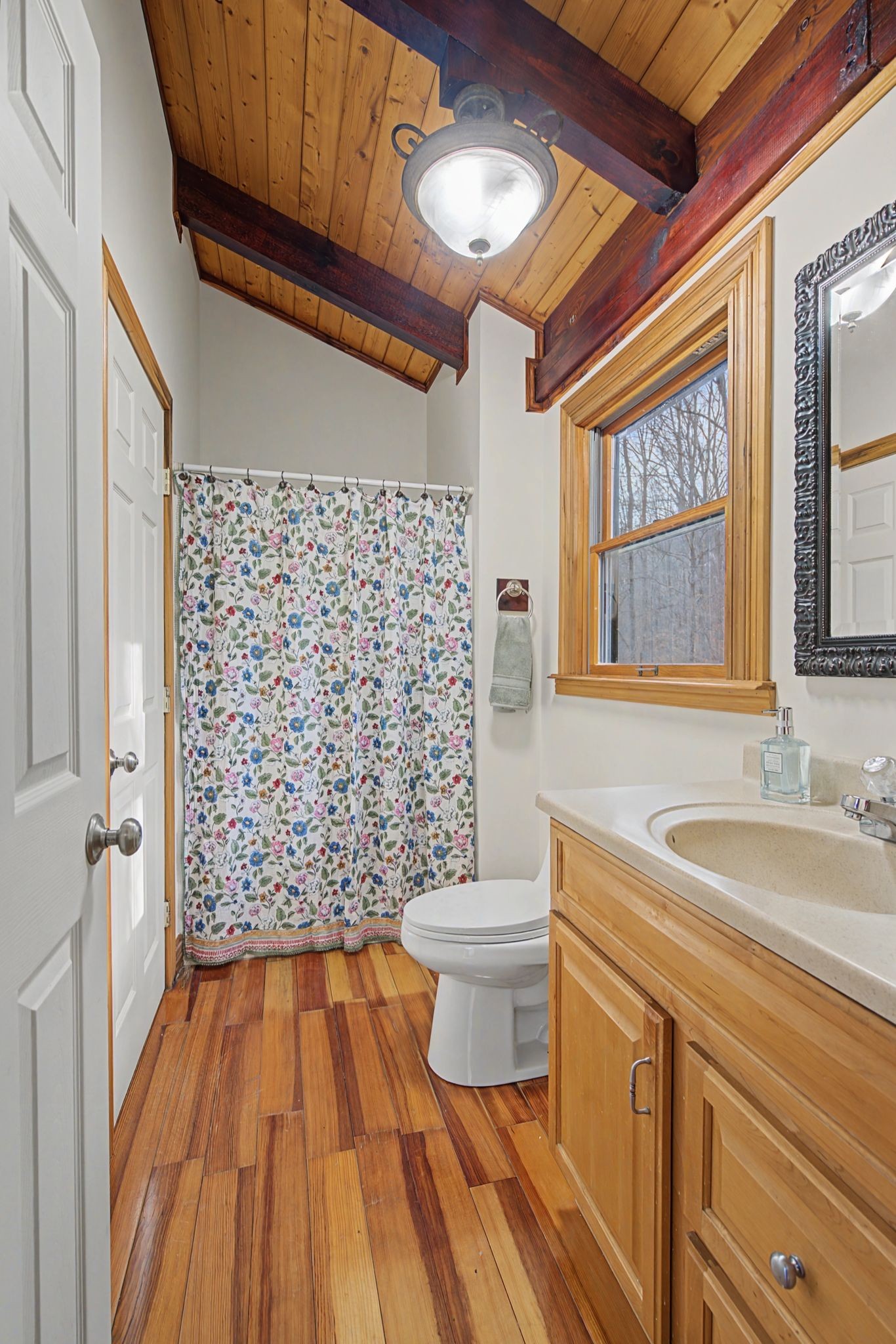 1146 Treanor Springs Road Kingston Springs, TN 37082 - Photo 12 of 31 a bathroom with a sink a toilet a window and shower