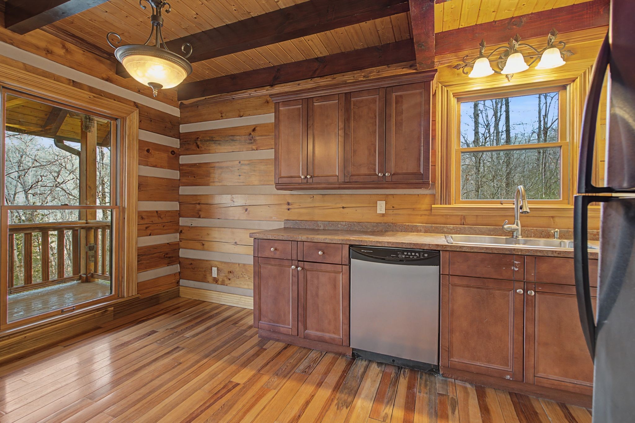 1146 Treanor Springs Road Kingston Springs, TN 37082 - Photo 5 of 31 a kitchen with granite countertop wooden floors and wide window