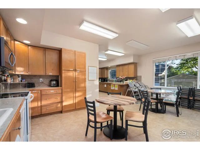 a kitchen with kitchen island a dining table and chairs