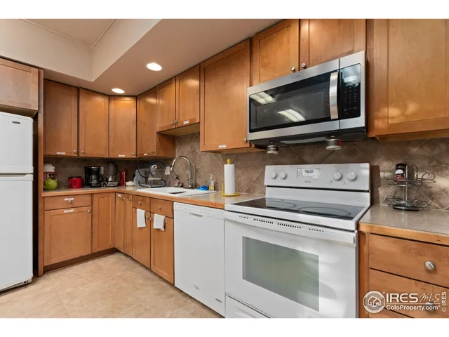 a kitchen with stainless steel appliances granite countertop a stove microwave and sink