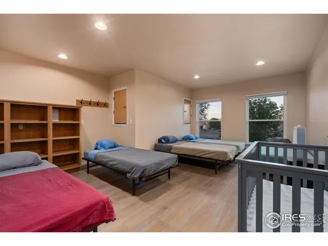 a bedroom with furniture and a wooden floor