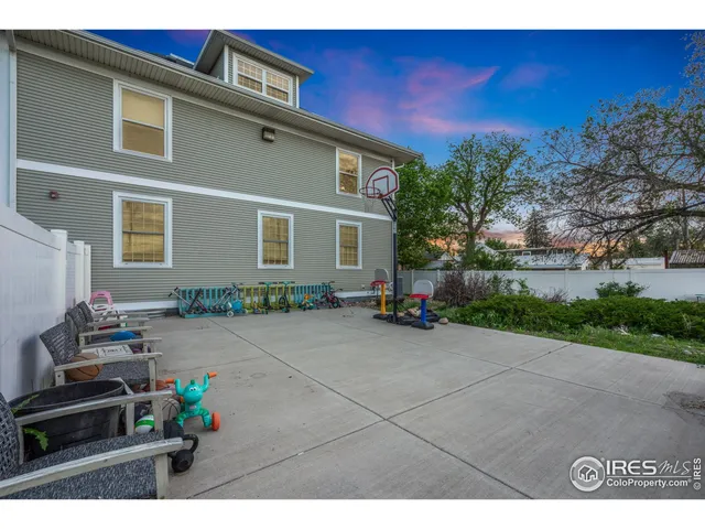 a backyard of a house with seating space and trees