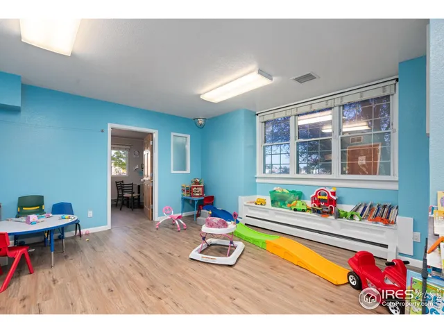 a living room with furniture and a dining table