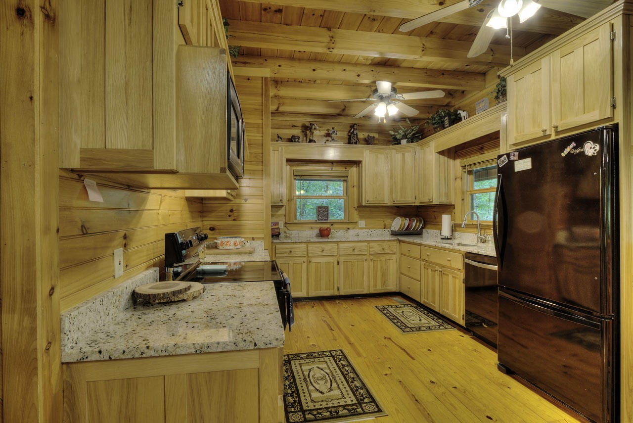 340 Doe Ridge Road Oneida, TN 37841 - Photo 8 of 40 a kitchen with sink cabinets and appliances