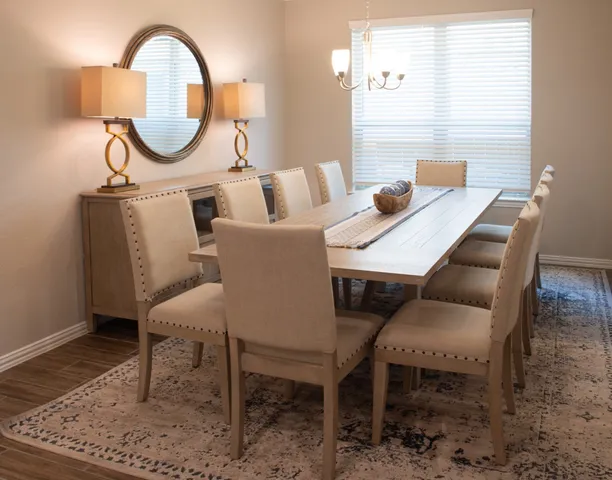 a dining room with furniture and a mirror