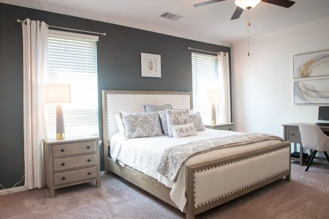 a bedroom with a bed and a chandelier