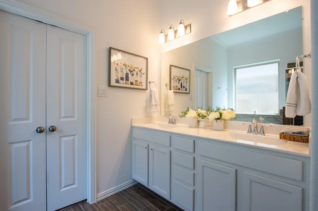 a bathroom with a double vanity sink and a mirror