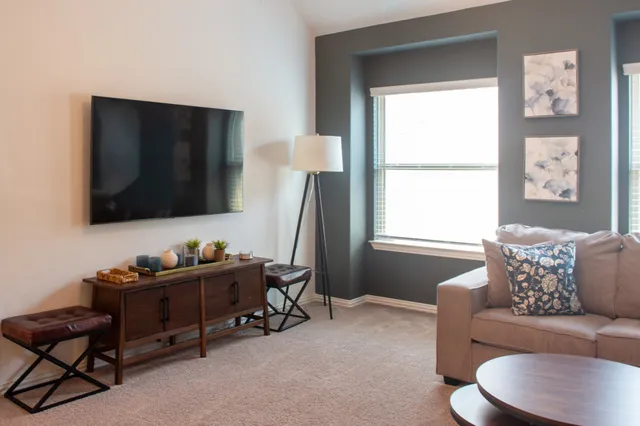 a living room with furniture and a flat screen tv