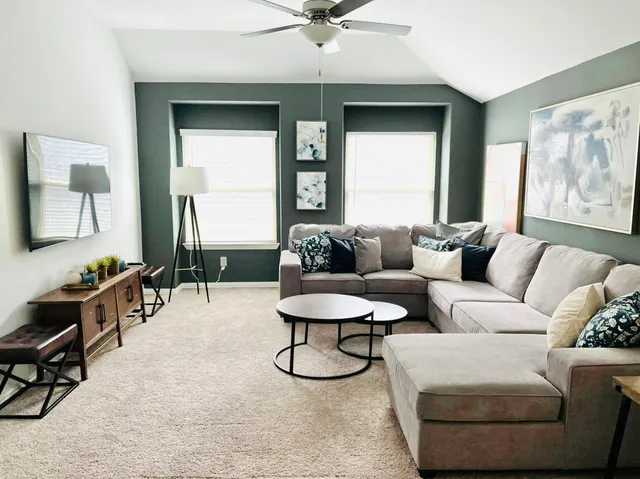 a living room with furniture and a window