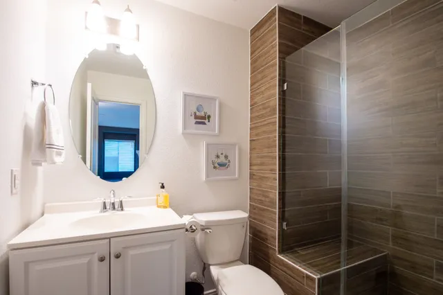 a bathroom with a toilet sink and mirror