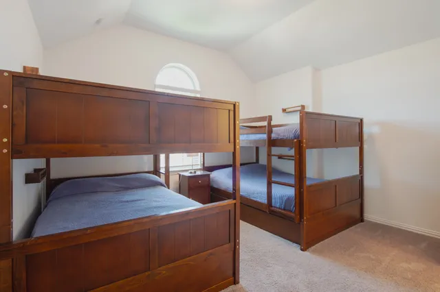 a view of a bedroom with furniture and window
