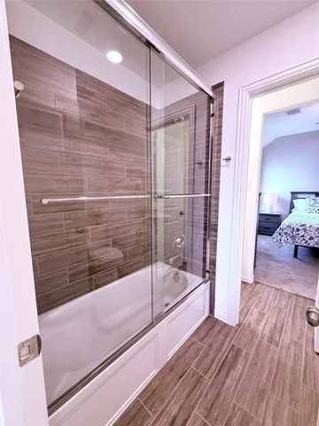 a bathroom with a bathtub and a shower