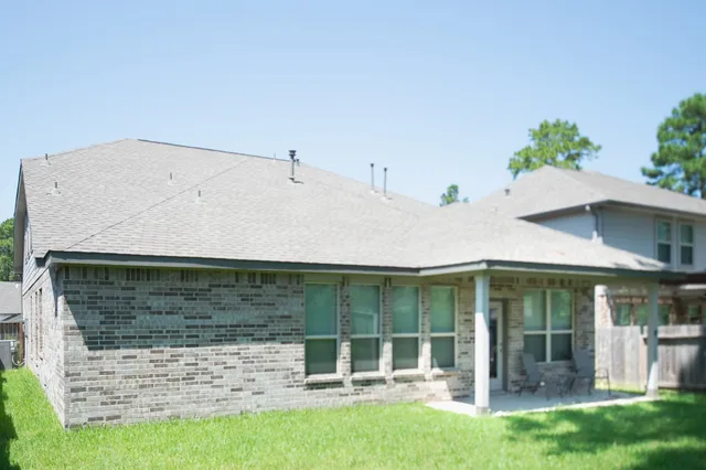 a backyard of a house with table and chairs