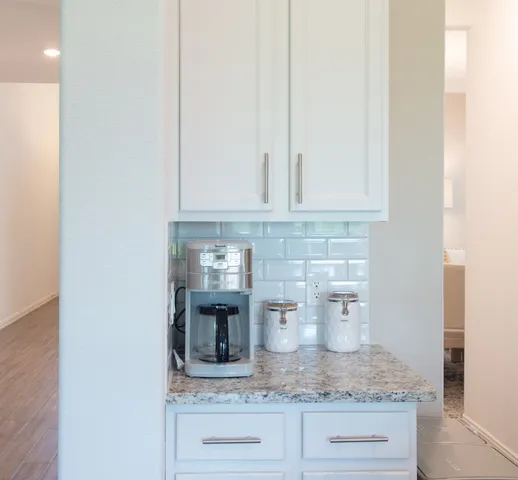 a kitchen with granite countertop white cabinets and a granite counter tops