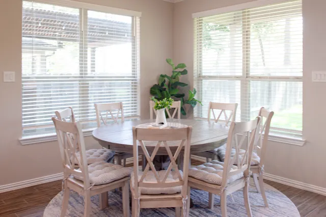 a dining room with furniture and wooden floor