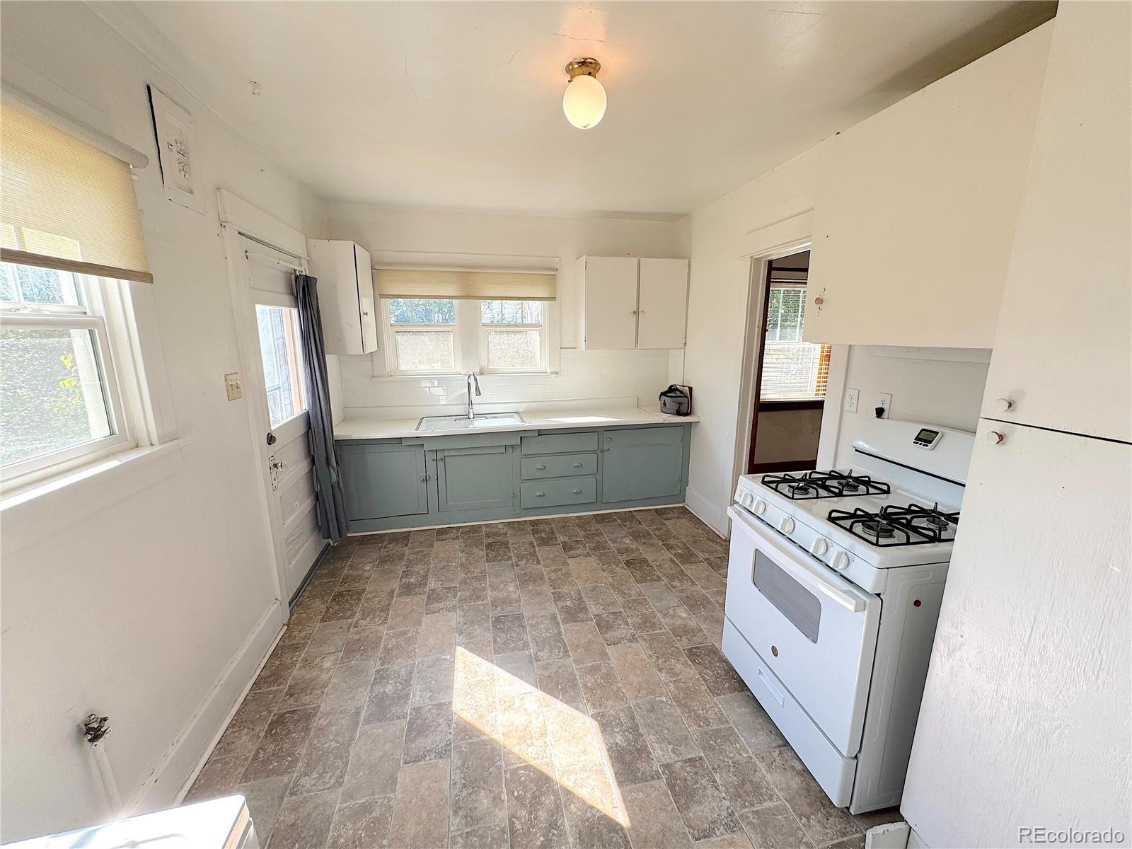 322 3rd Street Frederick, CO 80530 - Photo 18 of 30 a kitchen with stainless steel appliances granite countertop a stove a sink dishwasher and a refrigerator