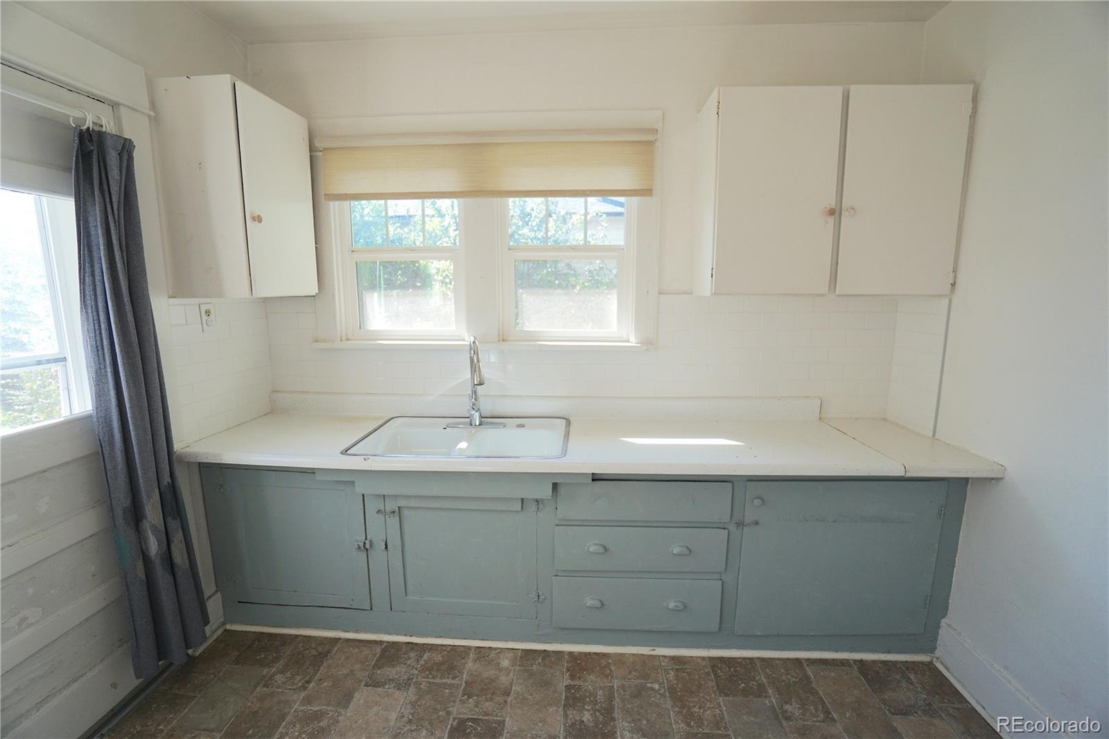 322 3rd Street Frederick, CO 80530 - Photo 19 of 30 a kitchen with a sink and window