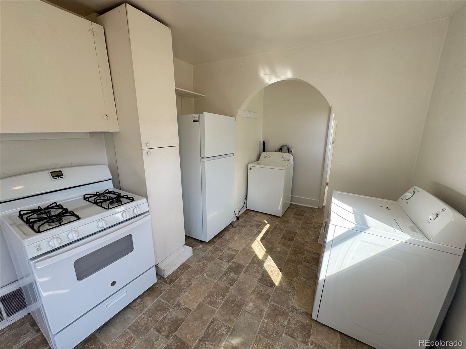 322 3rd Street Frederick, CO 80530 - Photo 20 of 30 a living room with a stove and a refrigerator
