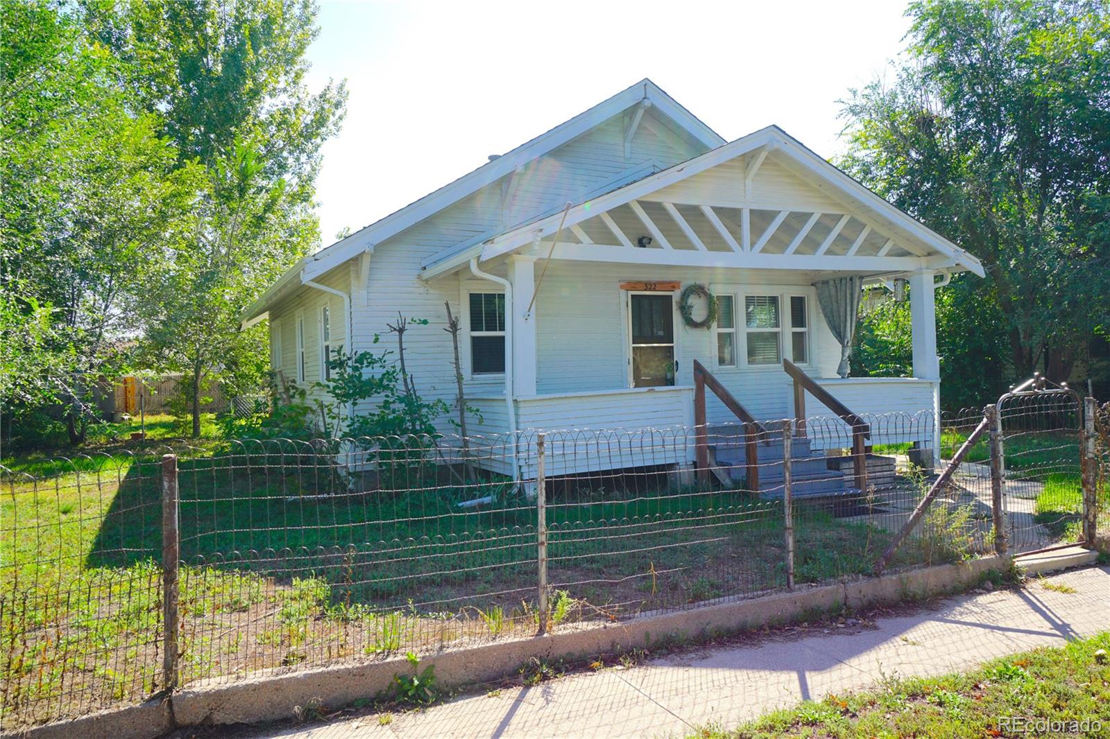 322 3rd Street Frederick, CO 80530 - Photo 2 of 30 a front view of a house with a yard and potted plants