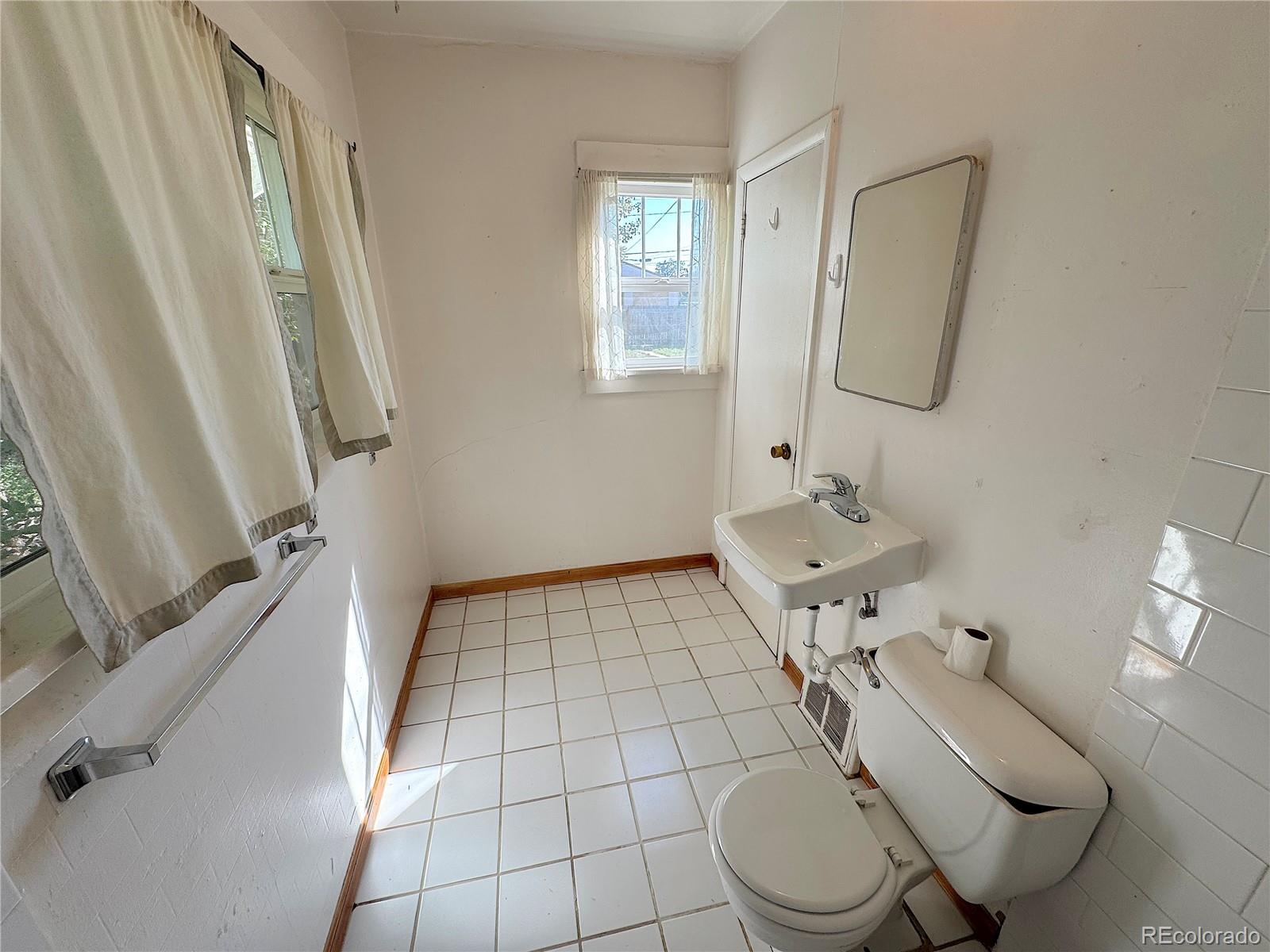 322 3rd Street Frederick, CO 80530 - Photo 24 of 30 a bathroom with a sink toilet and mirror