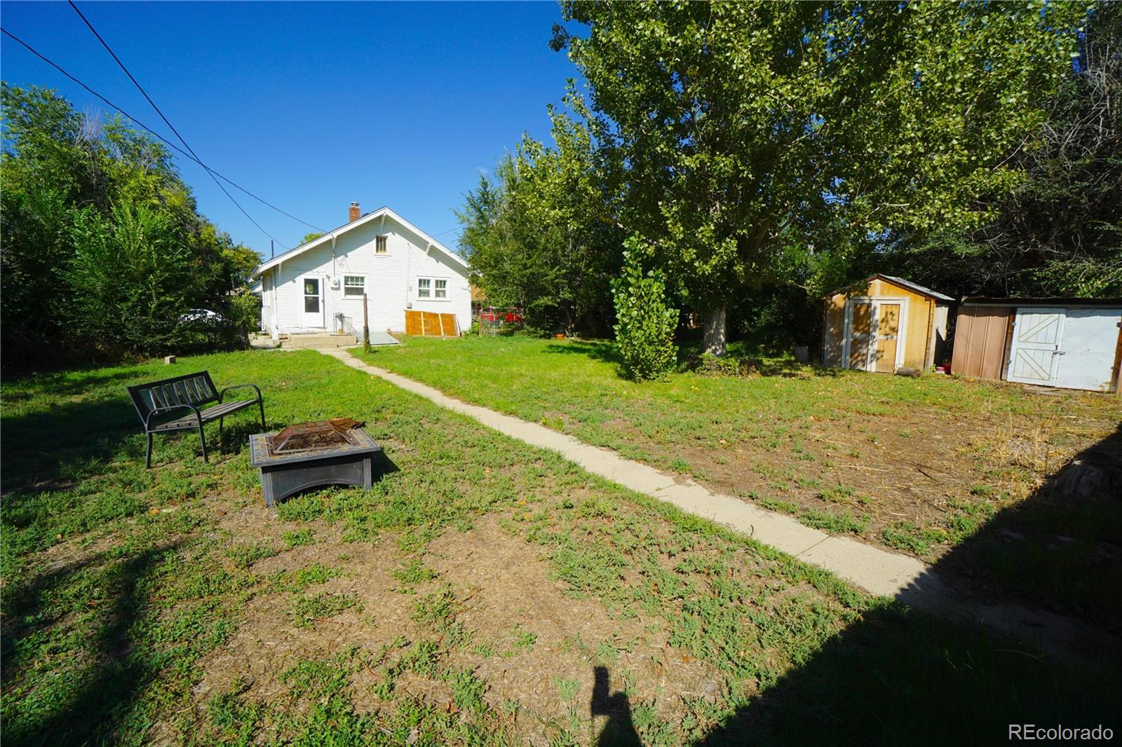 322 3rd Street Frederick, CO 80530 - Photo 7 of 30 a view of a house with a yard and sitting area