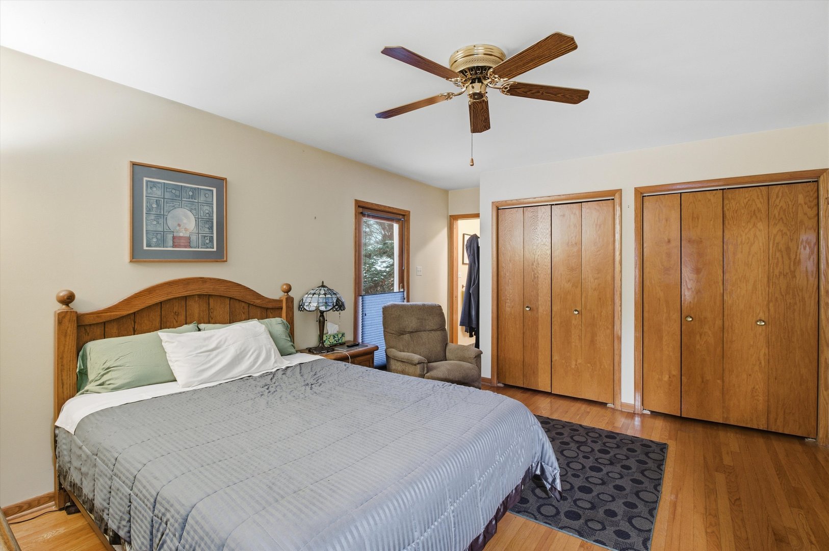 219 North Prospect Street Roselle, IL 60172 - Photo 12 of 34 a bedroom with a large bed and a chandelier