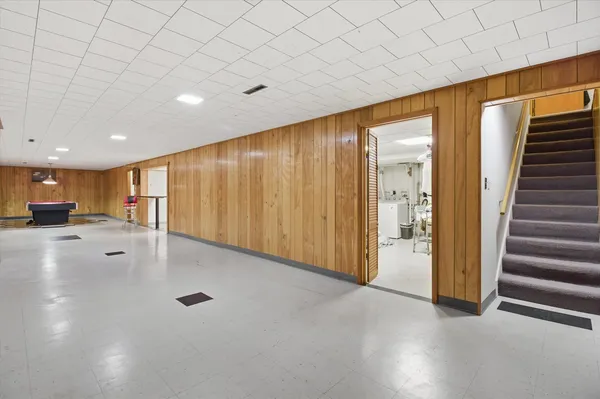 a living room with furniture gym equipment and a table